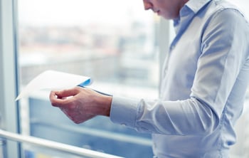 businessman-with-clipboard-and-papers-in-office-2024-09-27-15-58-56-utc