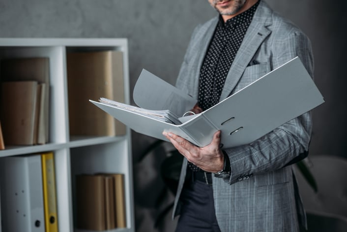 cropped-shot-of-businessman-holding-folder-and-wor-2024-11-01-05-16-13-utc-1