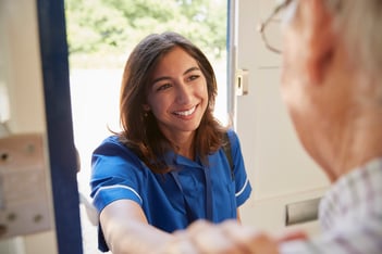 nurse-on-home-visit-greeting-senior-man-over-shou-2024-10-19-06-33-49-utc
