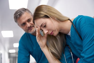 old-doctor-comforting-doctor-woman-in-hospital-cor-2023-11-27-04-54-35-utc